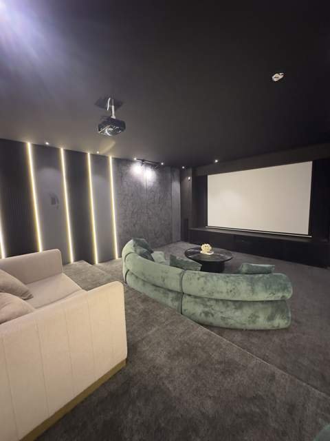Home theater with velvet seating and projection screen