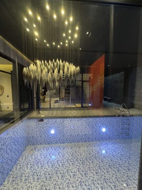 Indoor pool detail with hanging glass fixtures