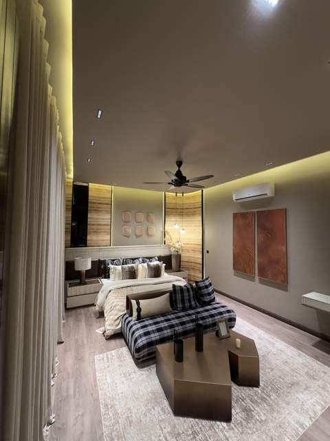 Bedroom suite with curved backlit wood paneling