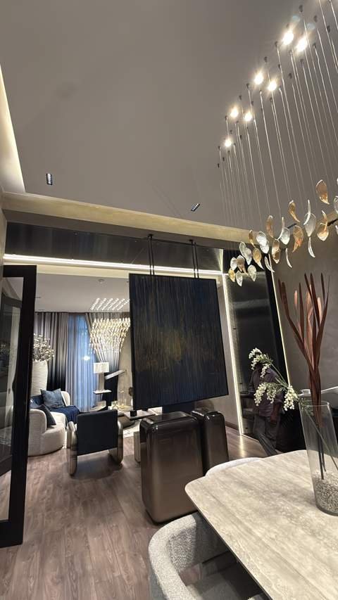Open-plan living and dining with pendant chandelier